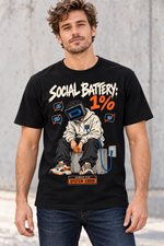 Male model wearing a black Social Battery 1% graphic T-shirt with low-battery screen-headed character and blue charging cable.
